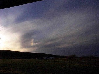 This great whorl in the sky was dusk. Thats a home in the distance.